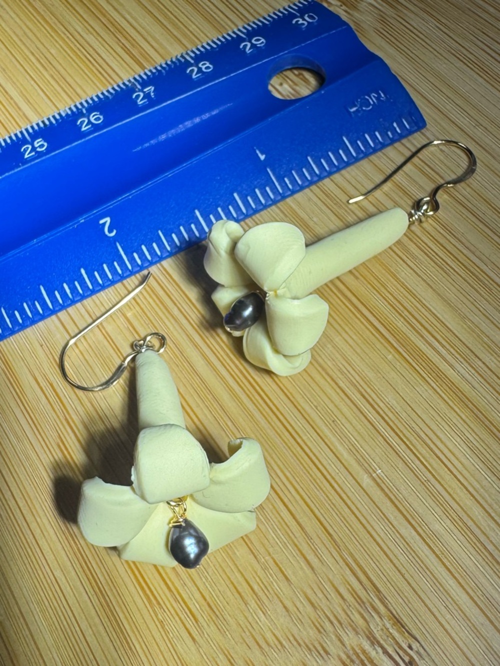 Elegant Cream Puakenikeni Floral Drop Earrings with Black Pearl Accent